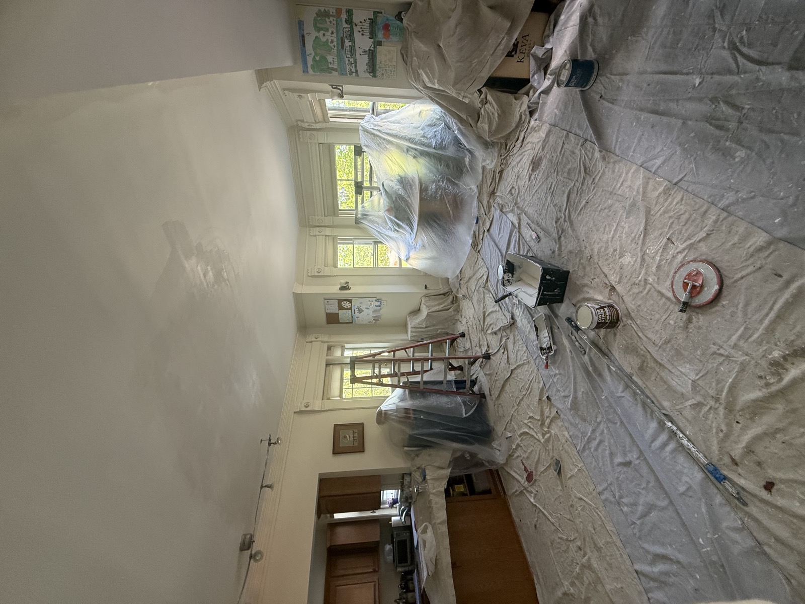 Interior painting prep with furniture covered and floors protected
