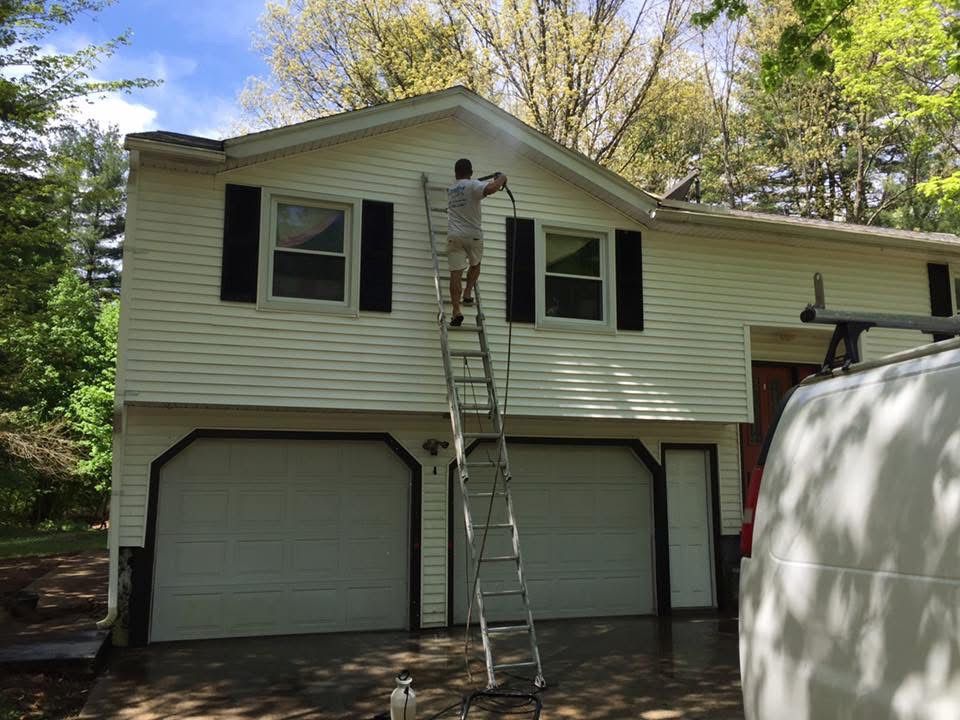 Creative Painting power washing the siding of a Massachusetts home