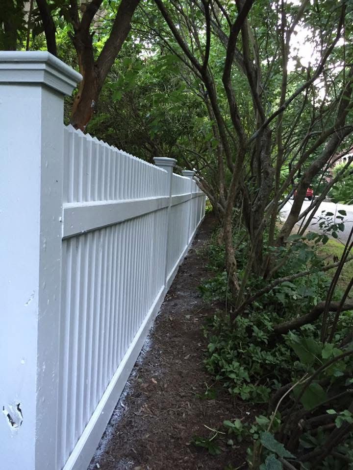 Fresh, clean white fence after power washing and repaint